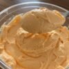 In our home, fluff desserts were always one of those clever “sneaky” treats my mom would make, packing in a little extra nutrition without anyone being the wiser. Her recipes always included cottage cheese, which meant our sweet indulgences were secretly full of protein. She would whip up these fluff-style desserts to keep in the fridge for quick weeknight treats. With their simplicity and minimal ingredients, they were the perfect solution for a busy mom juggling work and family. Although she made a variety of flavors—from lemon to strawberry-banana to pineapple—orange fluff has always been my personal favorite. White bowl filled with orange fluff set on a white tray. Cottage Cheese…In a Dessert? If you already love cottage cheese, you’re sold. If not, let me convince you. This orange fluff does not taste like cottage cheese—I promise! The secret is to puree the cottage cheese until it’s completely smooth. It adds a subtle tang and creamy texture to the dessert, but all you’ll notice is the luscious orange flavor. Three small white bowls filled with orange fluff, garnished with whipped cream and fresh orange slices. There’s something so delightful about a dessert that mimics my favorite ice cream—creamsicle—without much effort. Total win, if you ask me. (It’s also why I adore orange fruit dip!) When I went away to college, I worked as a server and actually saved up my tip money for a week to buy an inexpensive food processor from Meijer—just so I could have fluff whenever I wanted. That’s serious dedication, and it shows just how much I adore my mom’s sneaky orange fluff. Ingredients for orange fluff arranged on a beige countertop. How to Make My Mom’s Orange Fluff Orange fluff is one of the simplest desserts to prepare. That’s why Mom made it so often, but it’s also delicious enough to add to any holiday dessert table. Ingredients You’ll Need This recipe uses four basic ingredients plus one optional addition: Cottage cheese: Adds protein, a slight tang, and creamy texture. Orange Jell-O mix: Infuses the fluff with sweetness and orange flavor. Thawed whipped topping: Creates the airy, fluffy texture. Use Cool Whip, TruWhip, or stabilized whipped cream. Canned mandarin oranges: Provides sweet, juicy orange pieces in every bite. Optional – miniature marshmallows: Adds extra texture and sweetness if desired. Making the Recipe Puree the cottage cheese: Use a food processor to blend until completely smooth. Mix in Jell-O: Transfer the pureed cottage cheese to a bowl and whisk in the dry orange Jell-O mix until fully incorporated. Fold in whipped topping: Use a rubber spatula to gently fold in the thawed whipped topping. Add fruit and extras: Fold in mandarin oranges and marshmallows, if using. Chill: Cover the orange fluff and refrigerate for at least 2 hours to allow flavors to meld and the texture to set. Serve: Garnish with whipped cream and fresh orange slices for a pretty presentation. Chopped mandarin oranges being added to a bowl of orange fluff. FAQs Can I use fresh oranges instead of canned mandarin oranges? Canned mandarins are convenient since they’re peeled and ready to use. Fresh oranges can be used, but you’ll need to supreme them to remove pith and membrane. Fresh oranges are slightly less sweet than mandarins in syrup, so the final fluff may taste a bit less sweet. Can I make orange fluff ahead of time? Yes! The fluff needs at least 2 hours in the fridge, so you can prepare it a day or two in advance. It will keep for up to 3 days. Can I freeze this orange fluff? Freezing is not recommended. Cottage cheese can separate when frozen and thawed, which may leave the fluff watery and less creamy. Can I use other Jell-O flavors? Absolutely! One of the best things about Mom’s fluff recipes is their versatility. Swap flavors of Jell-O and fruit to create your own variations—for example, pineapple fluff uses pineapple Jell-O and canned pineapple. Orange Fluff A light, dreamy dessert that comes together in minutes and is perfect for any occasion! Creamy cottage cheese blends with orange Jell-O and whipped topping for a sweet, citrusy treat. Prep Time: 10 minutes Chill Time: 2 hours Total Time: 2 hours 10 minutes Servings: 10 Equipment: Food processor Large mixing bowl Rubber spatula Ingredients 16 oz cottage cheese 2 boxes orange Jell-O mix (3 oz each) 16 oz frozen whipped topping, thawed 2 cans mandarin oranges (11 oz each), drained and roughly chopped 2 cups miniature marshmallows (optional) Instructions Puree cottage cheese in a food processor until smooth. Transfer to a large bowl and whisk in dry Jell-O mix until fully incorporated. Fold in whipped topping with a rubber spatula until no streaks remain. Gently fold in mandarin oranges (and marshmallows, if using). Cover and refrigerate for at least 2 hours. Serve chilled, optionally topped with extra whipped topping and fresh orange slices. Notes Adding miniature marshmallows gives extra texture and sweetness. Orange Fluff
